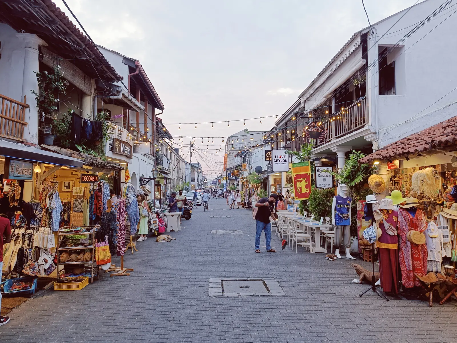 Shops and historic buildings along a lively street inside Galle Fort